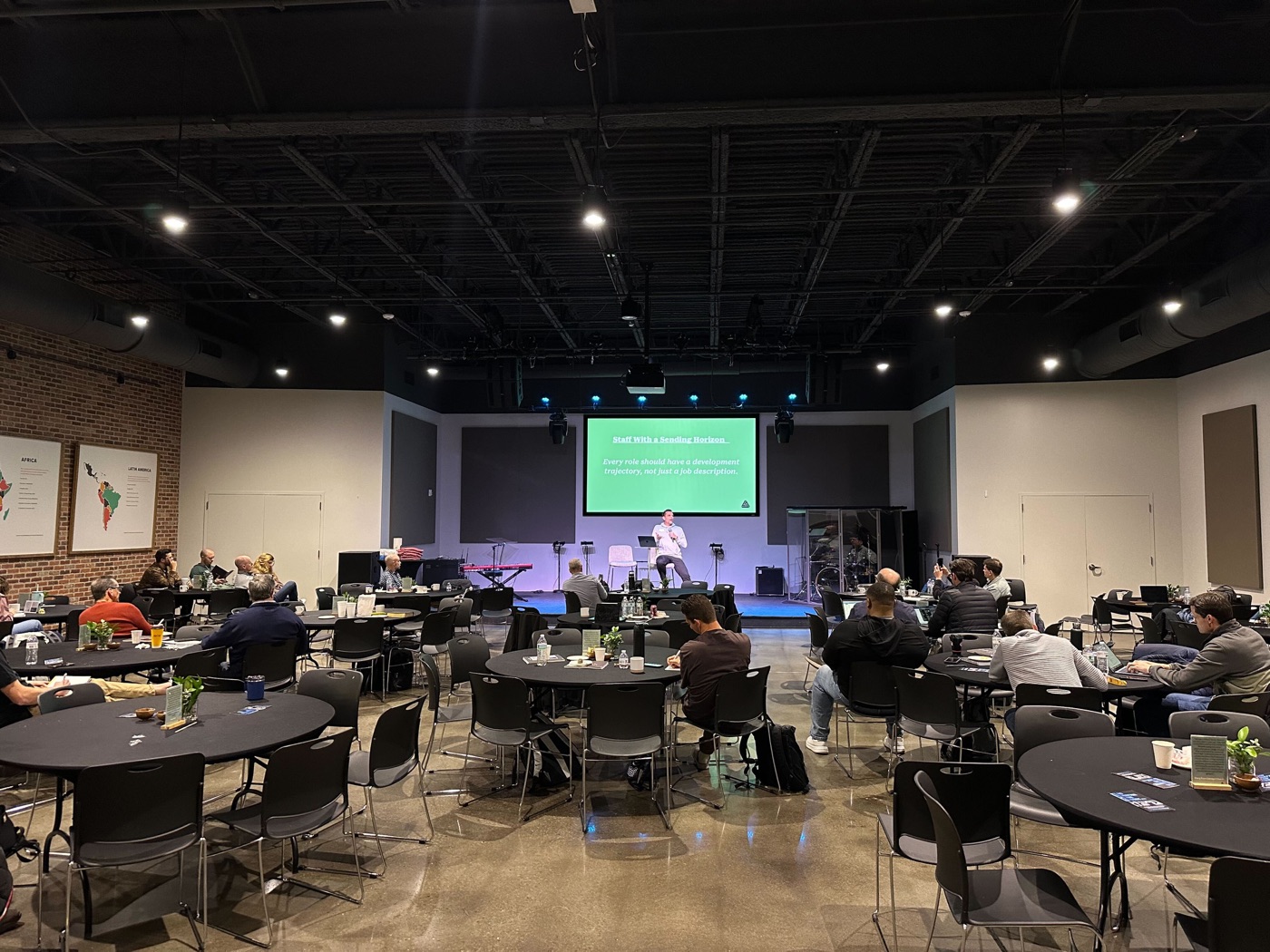 Church planters gathered at tables during a cohort session