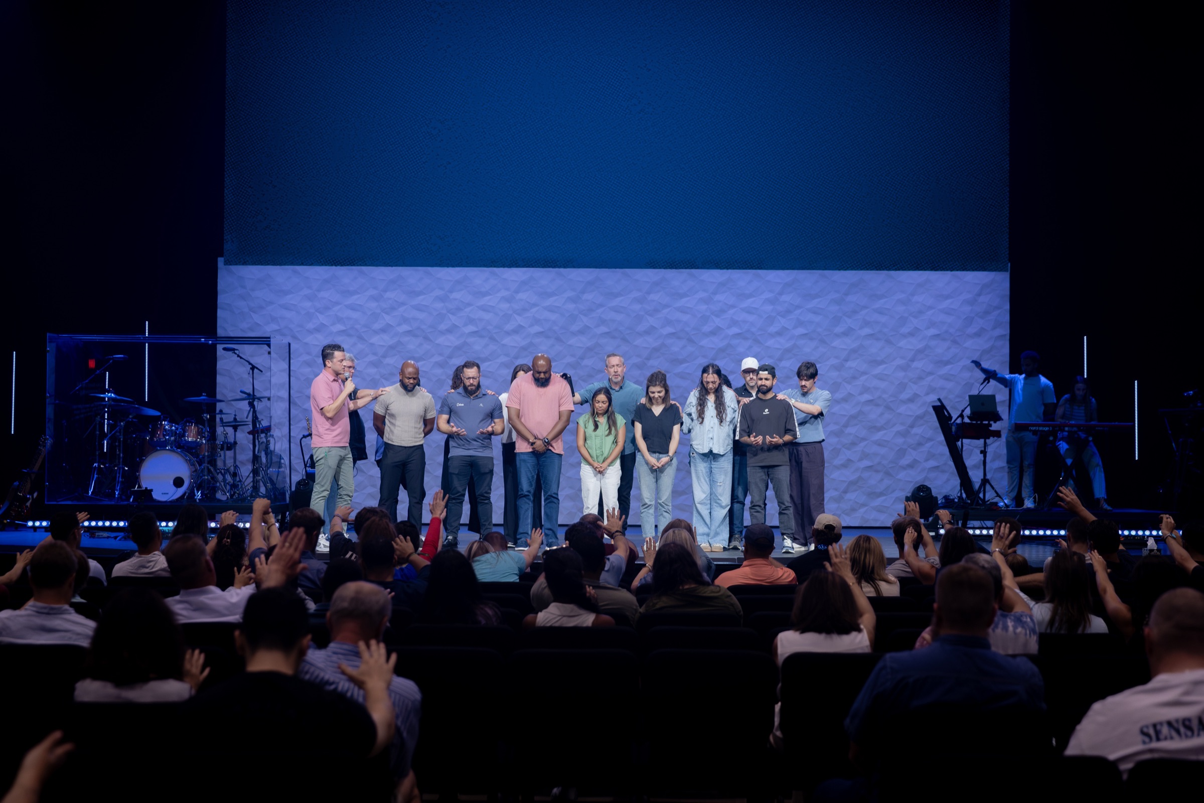 Church planters being commissioned on stage before the congregation